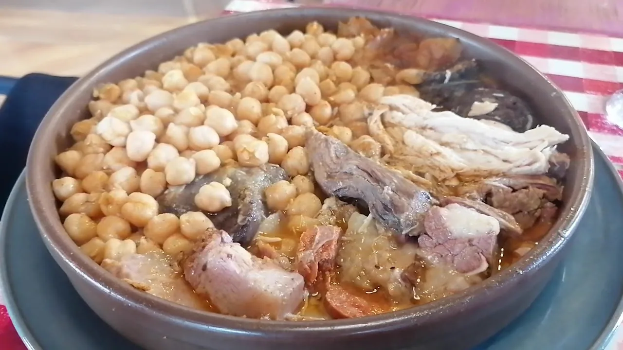 A bowl of chickpea stew with meat (cocido)