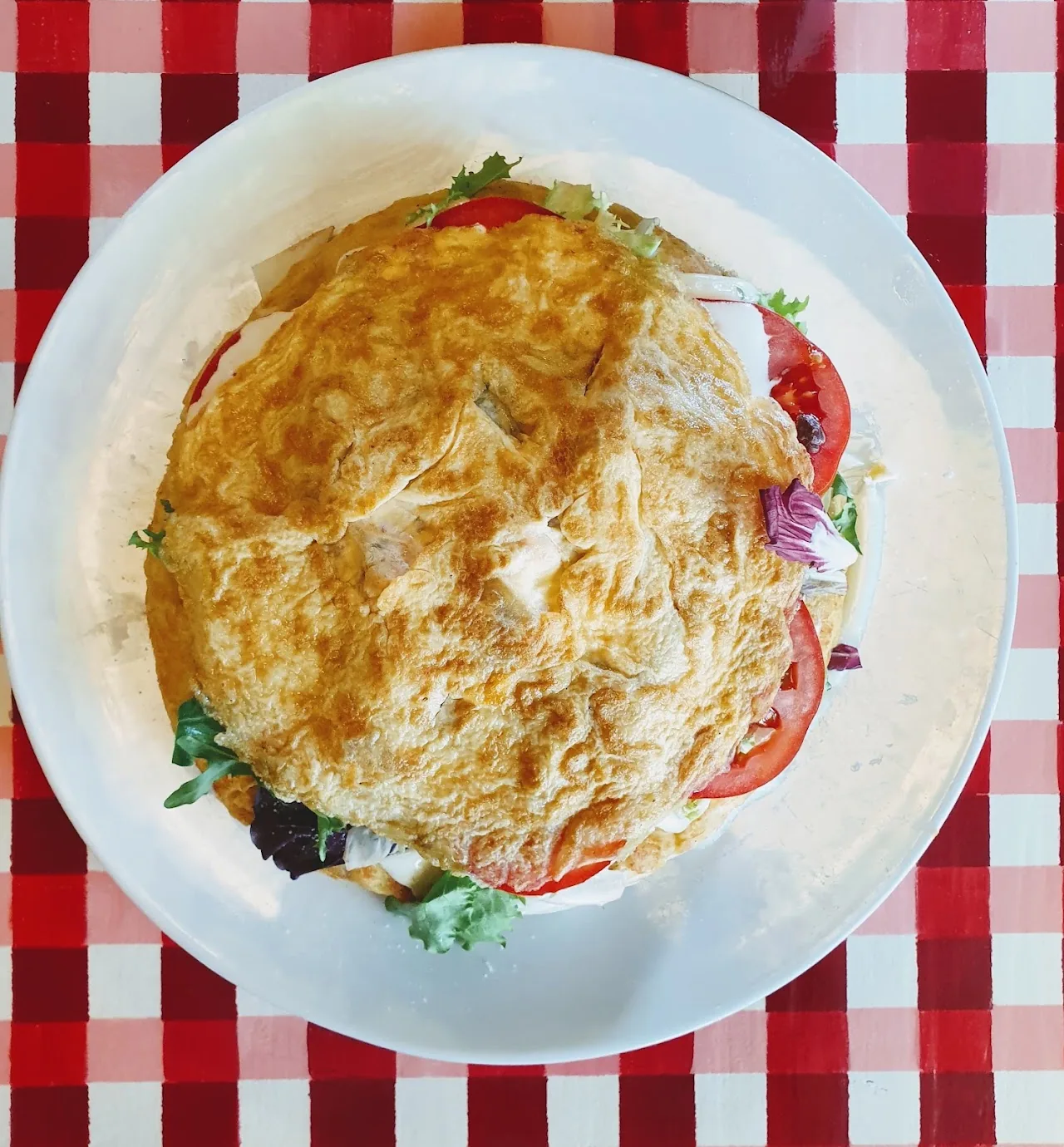 A Spanish tortilla served with tomato and onion salad