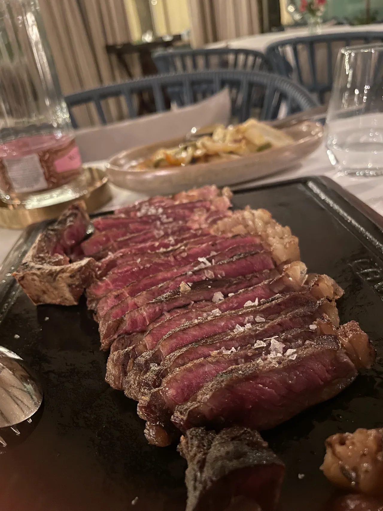 A sliced grilled steak on a wooden board