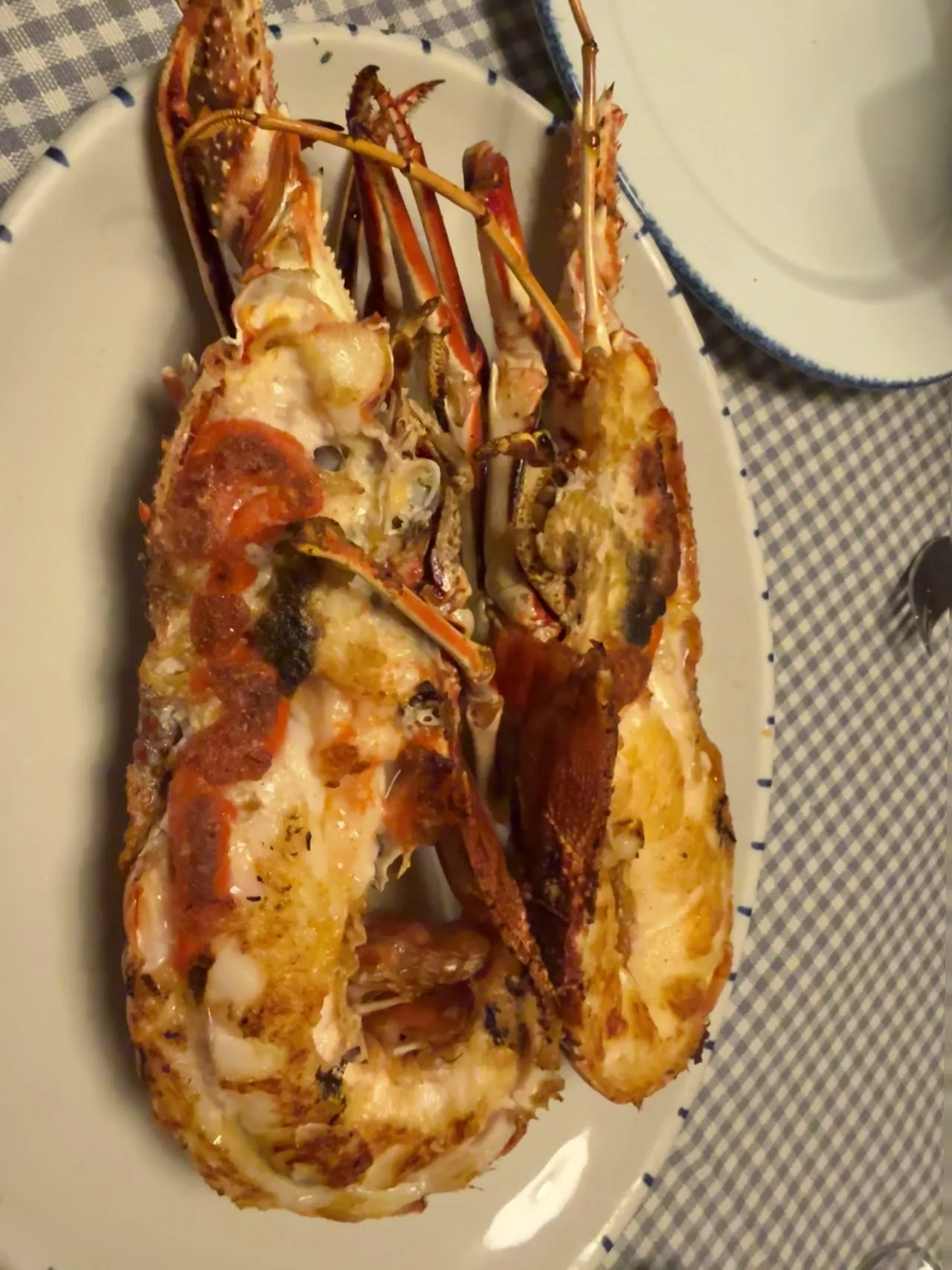 A grilled split lobster on a plate