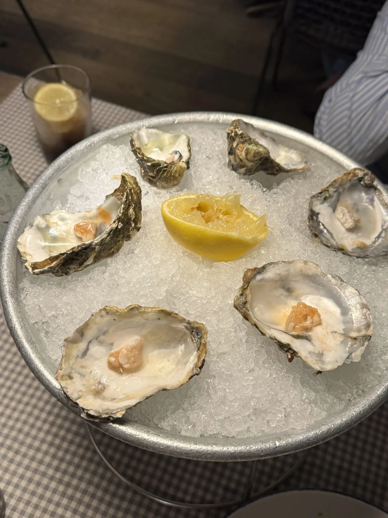 Oysters and a lemon half on a bowl of ice