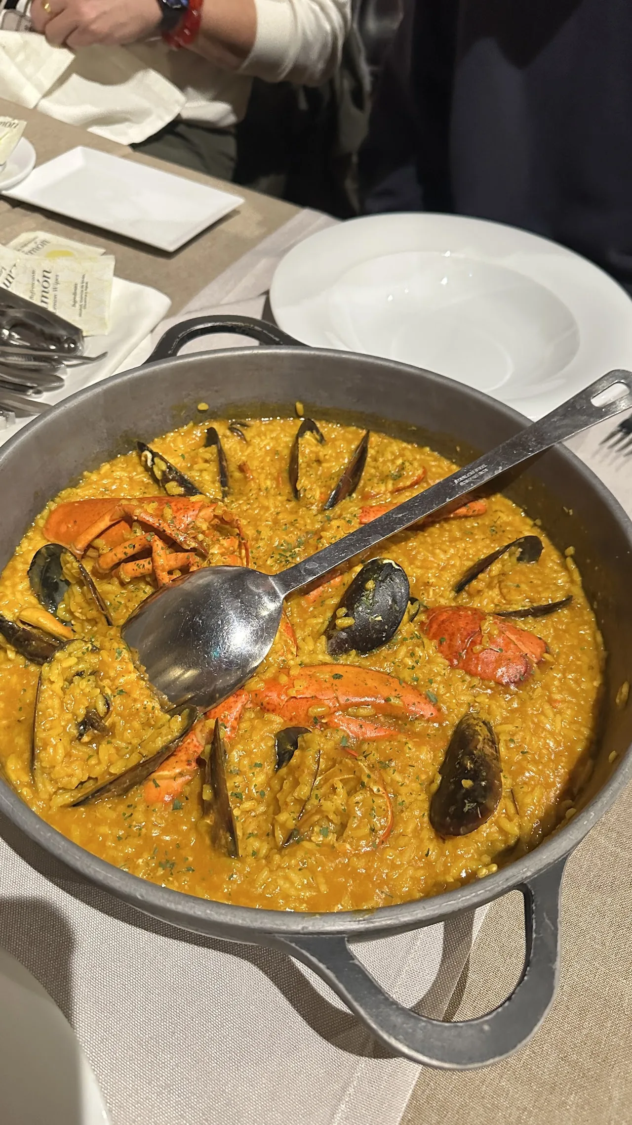 A pan of seafood rice with mussels and shrimp