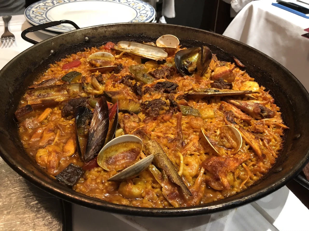 A seafood paella with mussels and clams in a pan