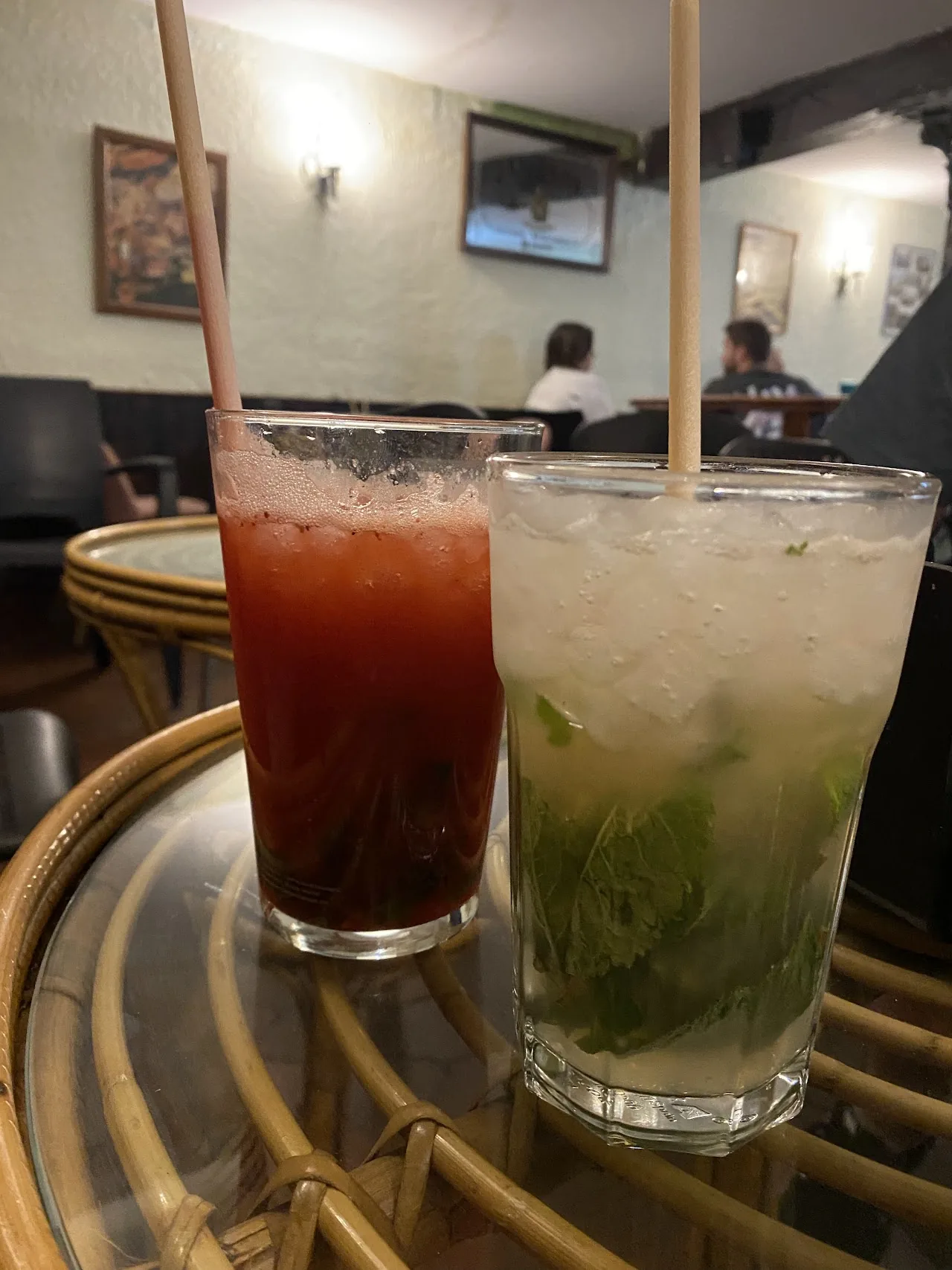 A red cocktail and a green mojito served together
