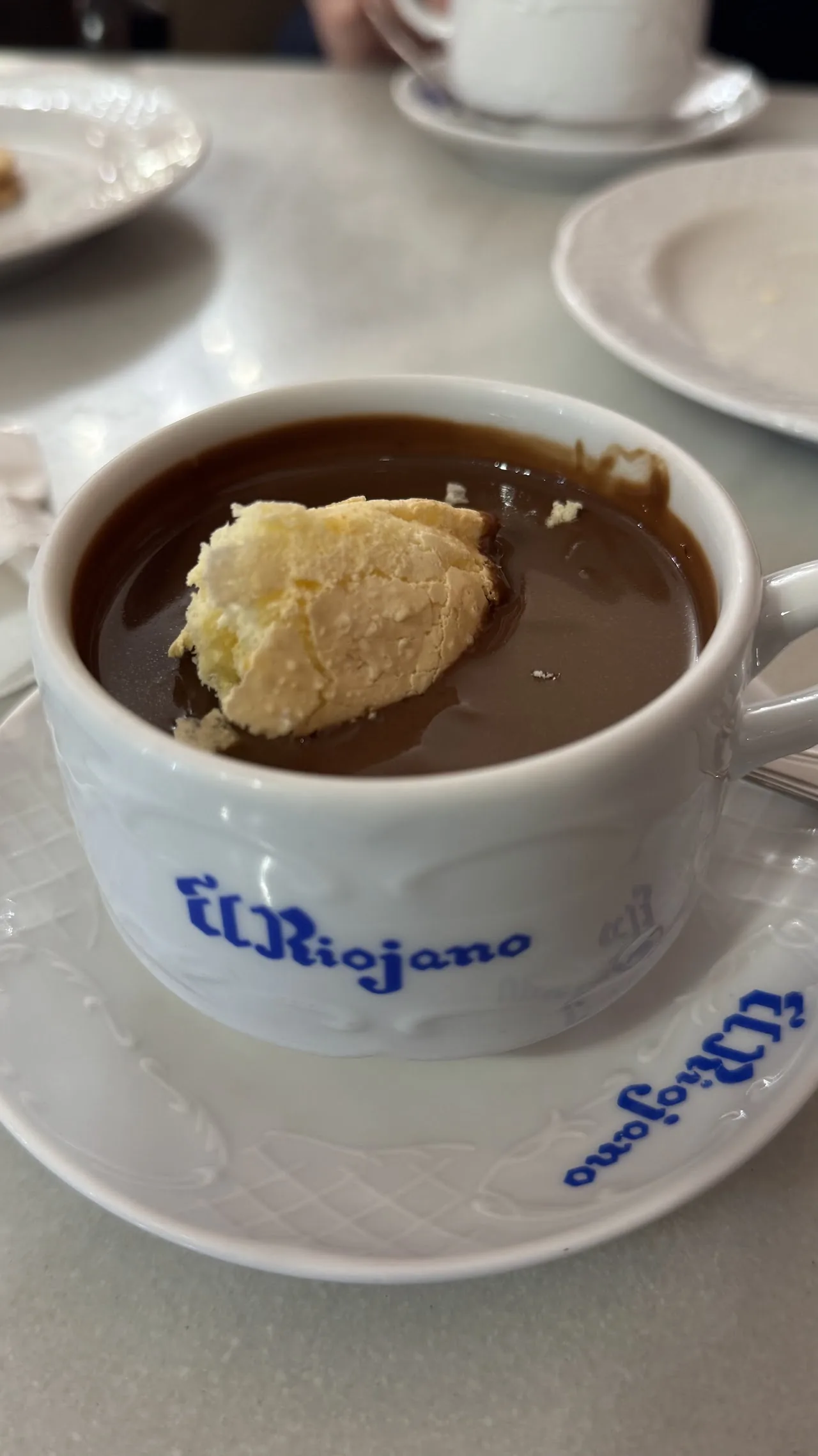 A cup of thick hot chocolate topped with whipped cream