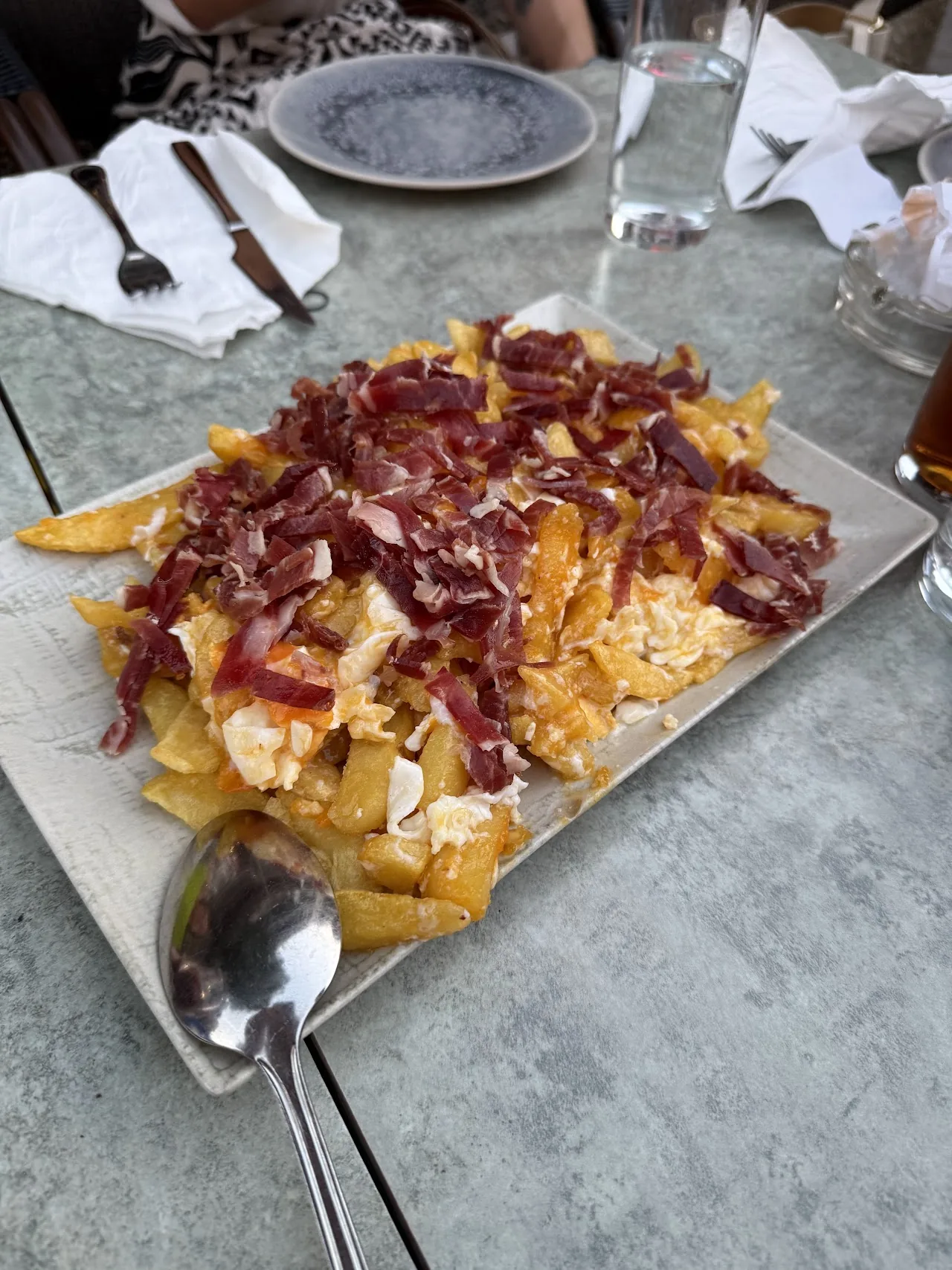 A plate of cured ham with fries