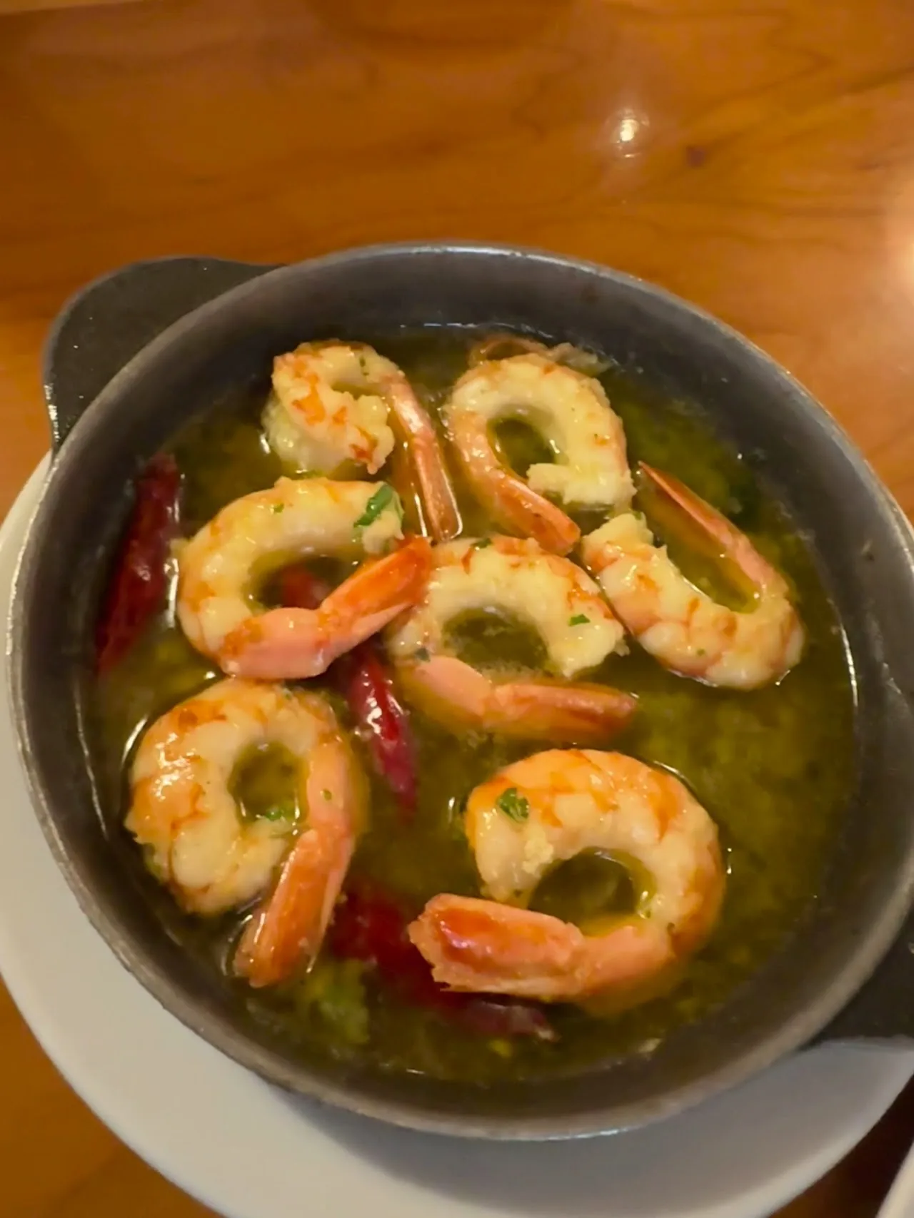 A pan of garlic shrimp in olive oil with chili