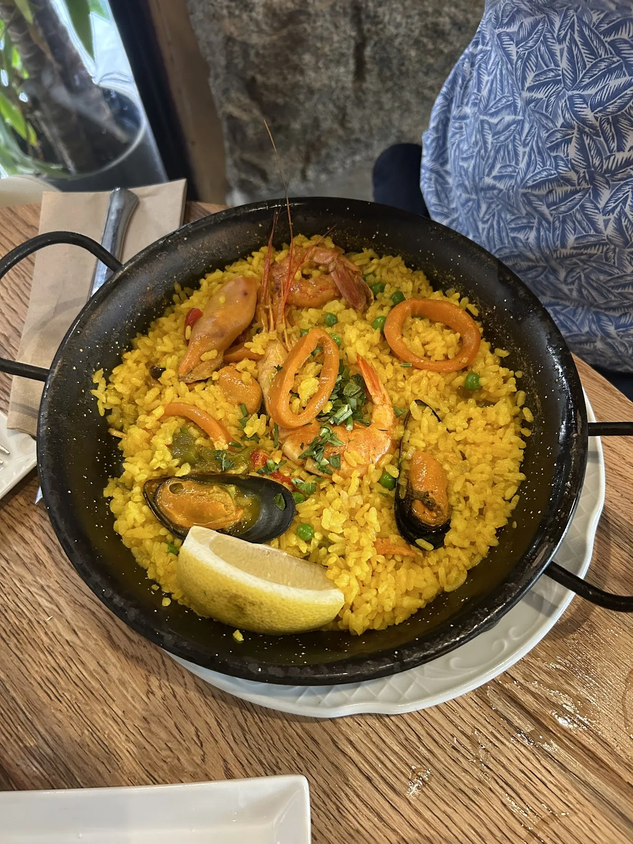 A seafood paella with mussels and shrimp in a pan