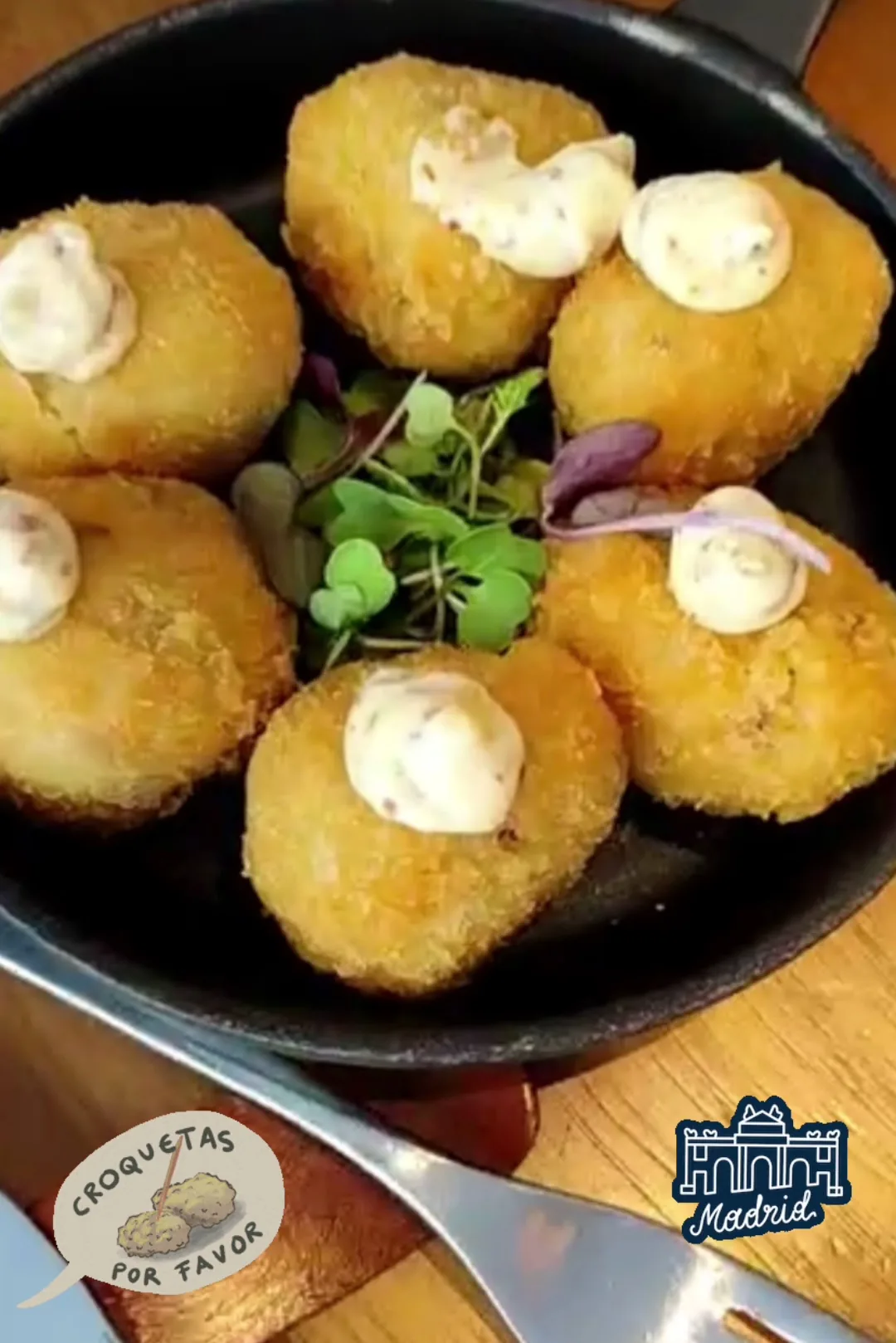 Breaded croquettes topped with a cream sauce
