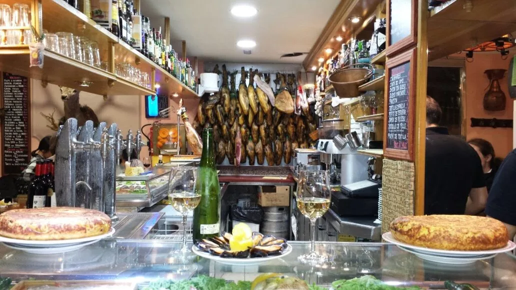 Spanish tortillas displayed on a bar counter