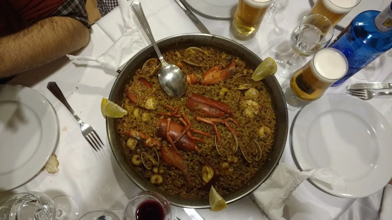 A seafood paella with shrimp in a pan on the table