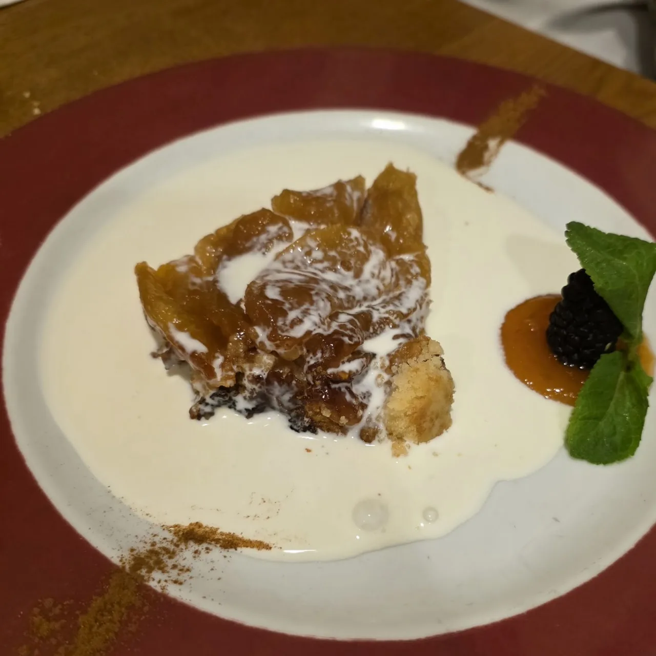 A dessert pastry with cream sauce and a garnish