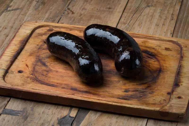 Two blood sausages on a wooden board