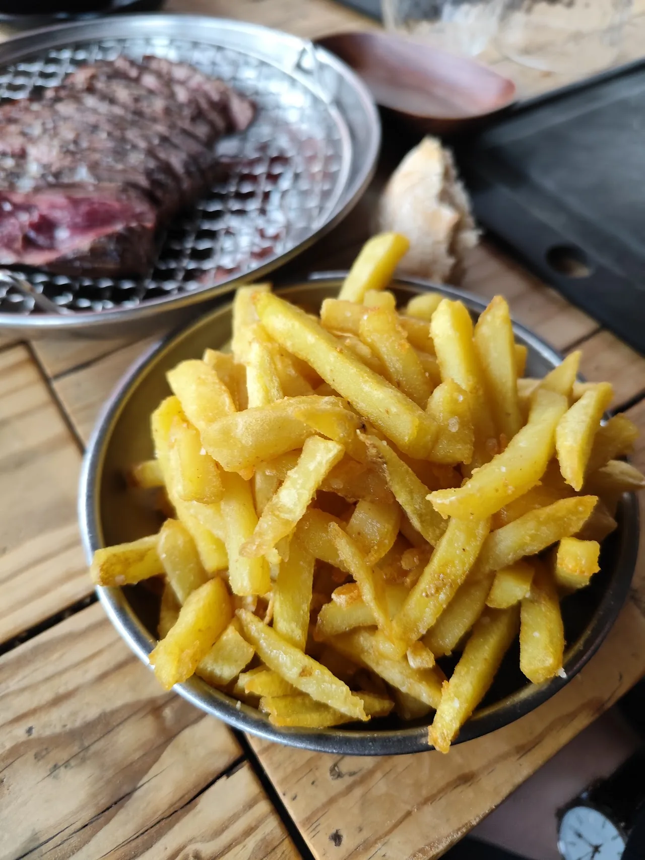 A grilled steak served with a side of fries