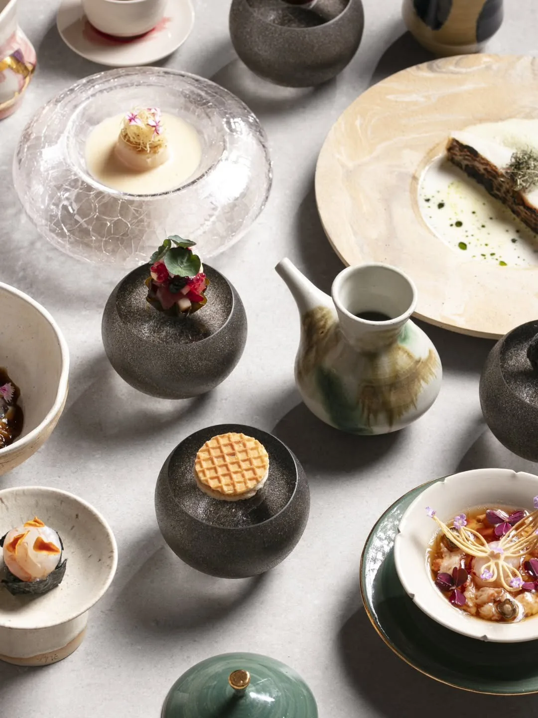 Several small dishes and bowls arranged on a white table