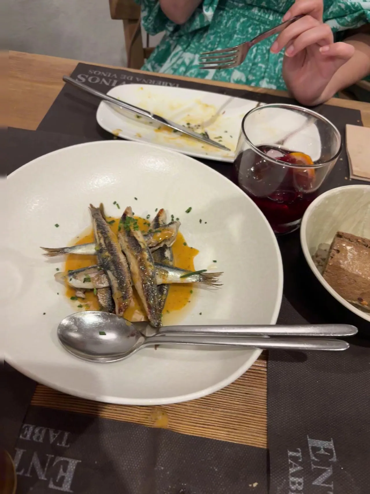 A plate of anchovies in olive oil with bread