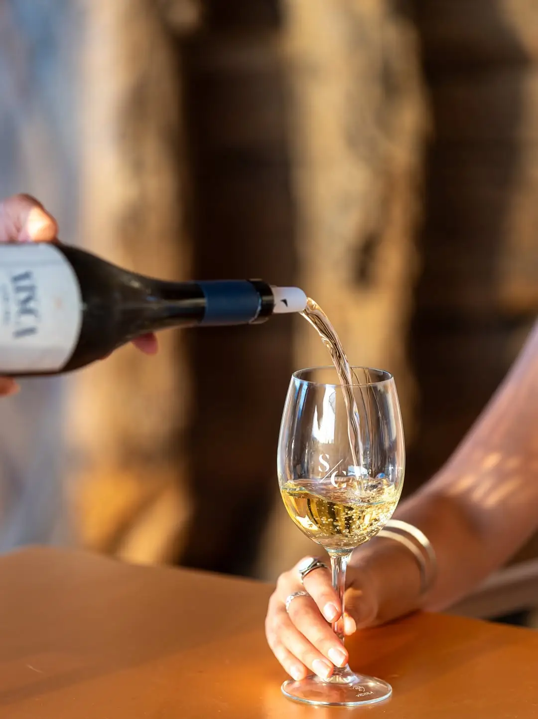 Pouring a glass of Sa Cabaña white wine