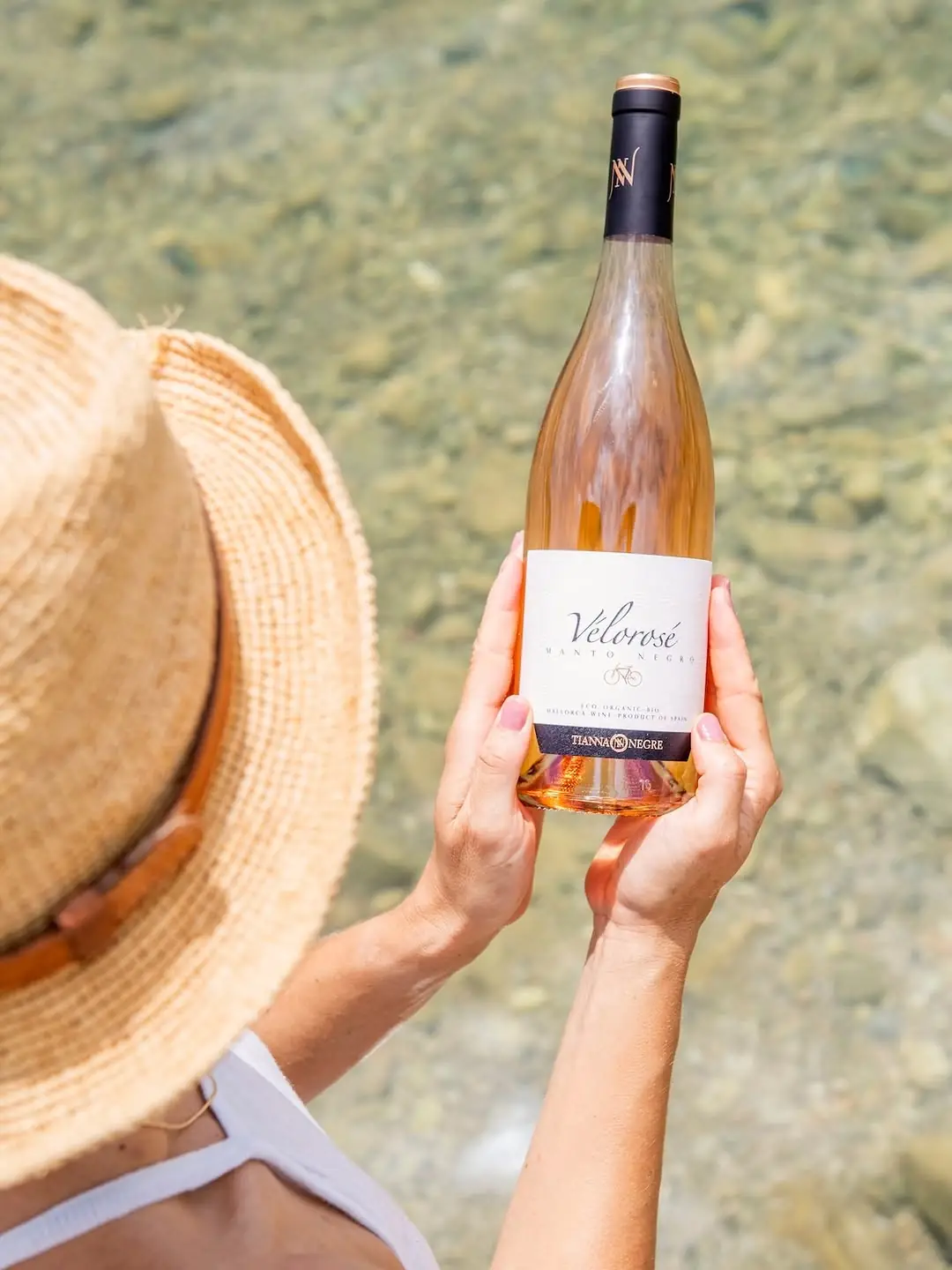 Holding up a bottle of Tianna Negre rosé