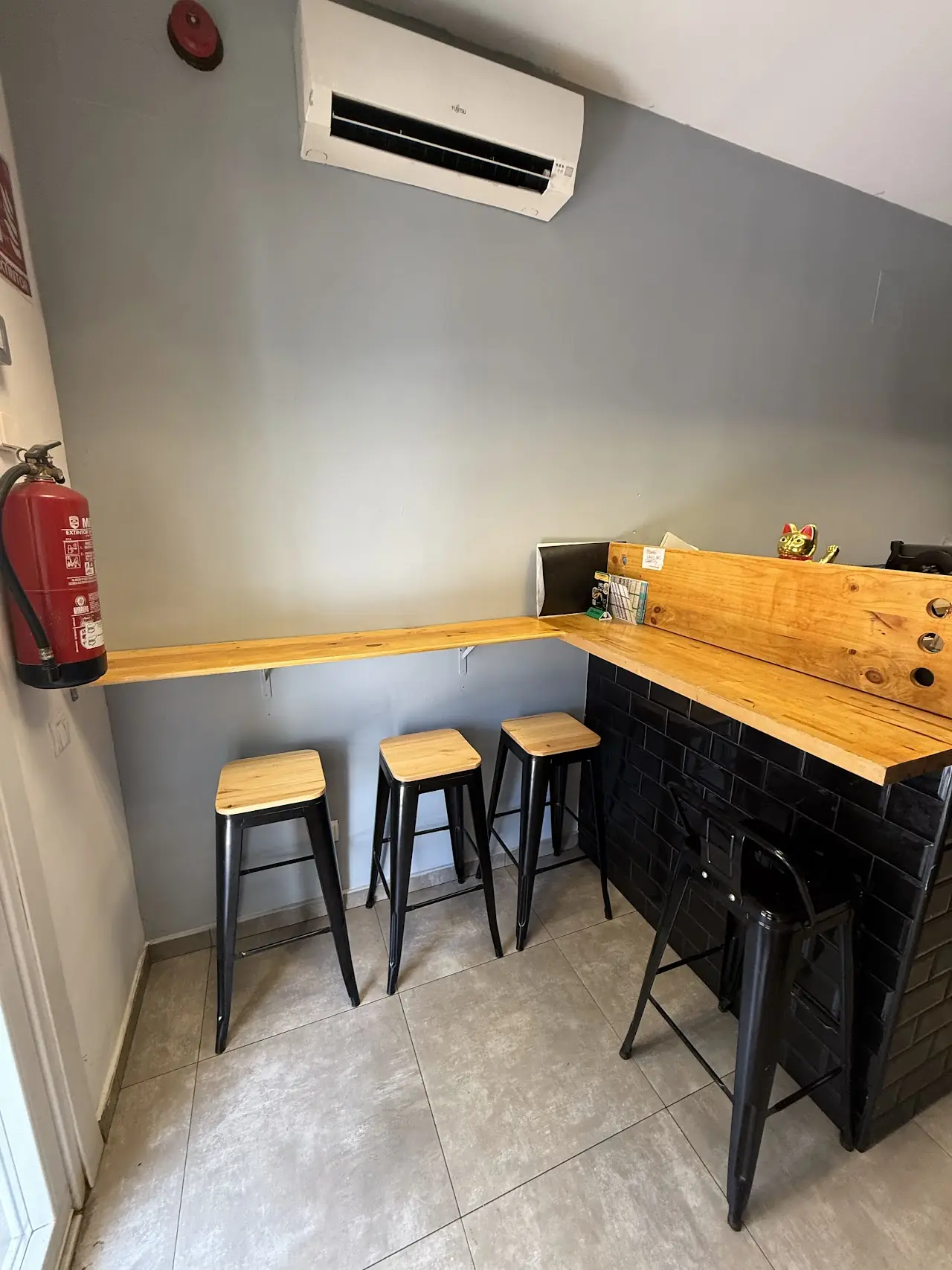 The small dining area with a wooden counter and bar stools.