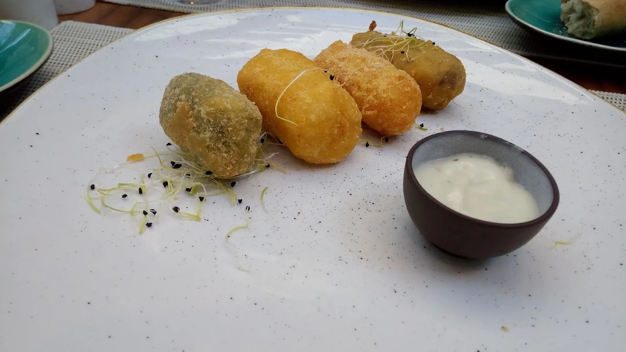 Fried croquettes with a small bowl of dipping sauce