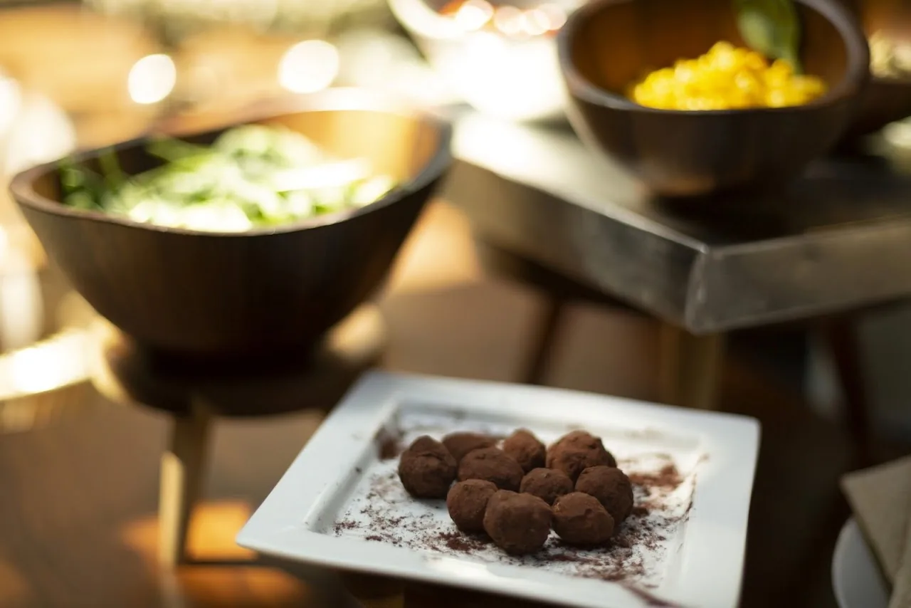 Chocolate-dusted truffle bites on a plate