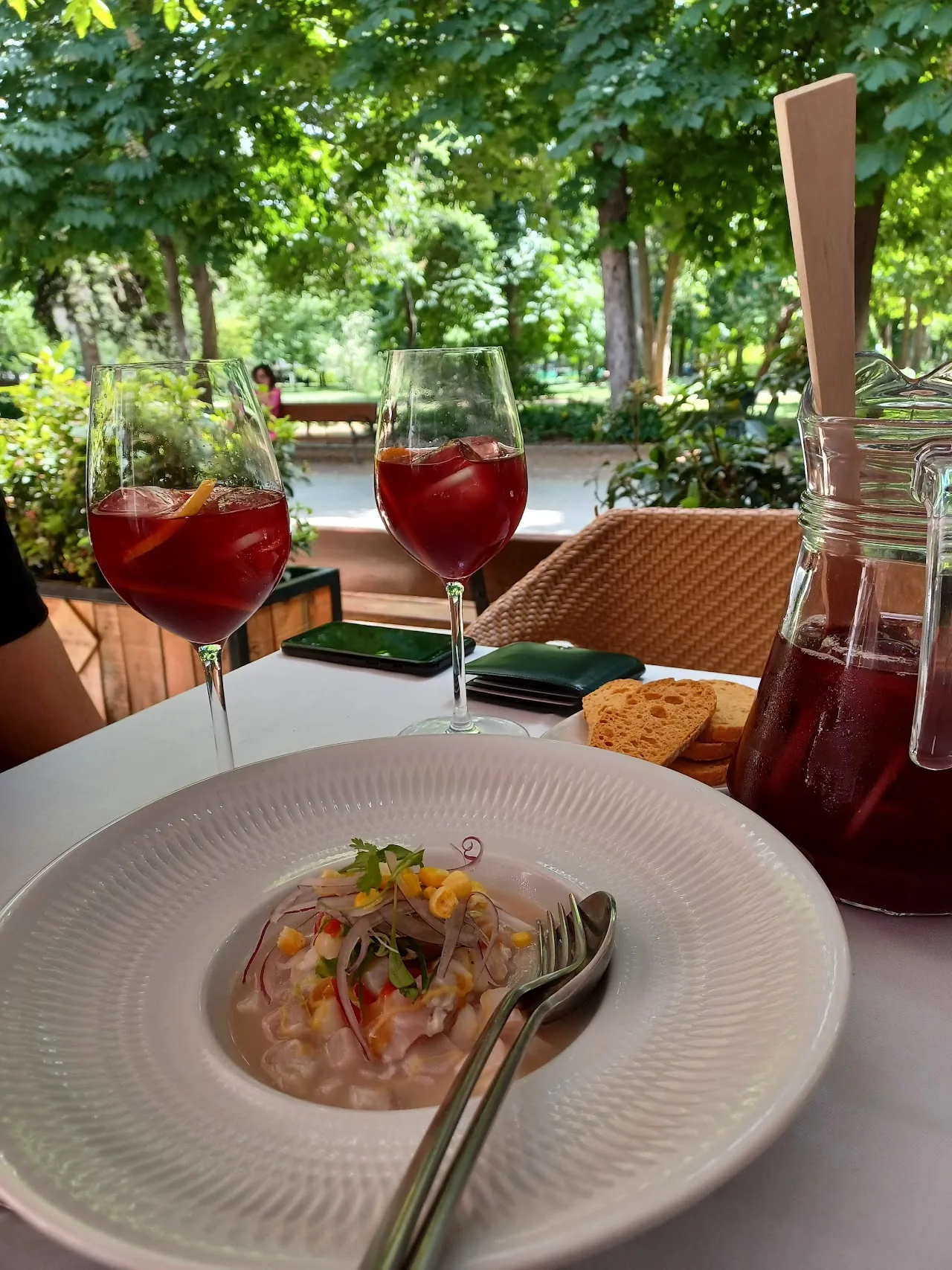 A plate of tartare beside two glasses of red sangria
