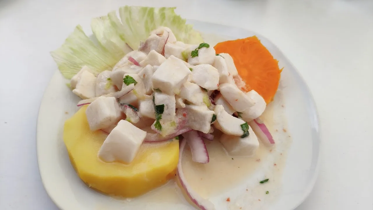 A plate of ceviche with corn, sweet potato, and red onion