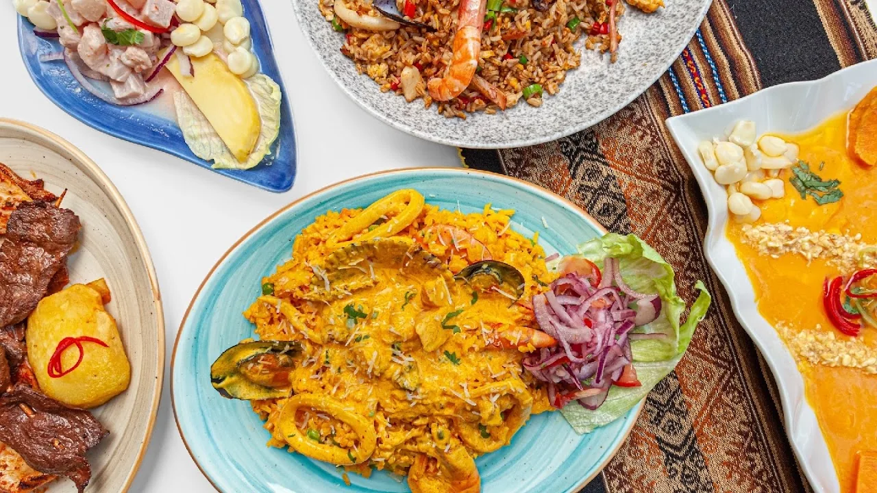 A colorful seafood platter with rice, ceviche, and shellfish