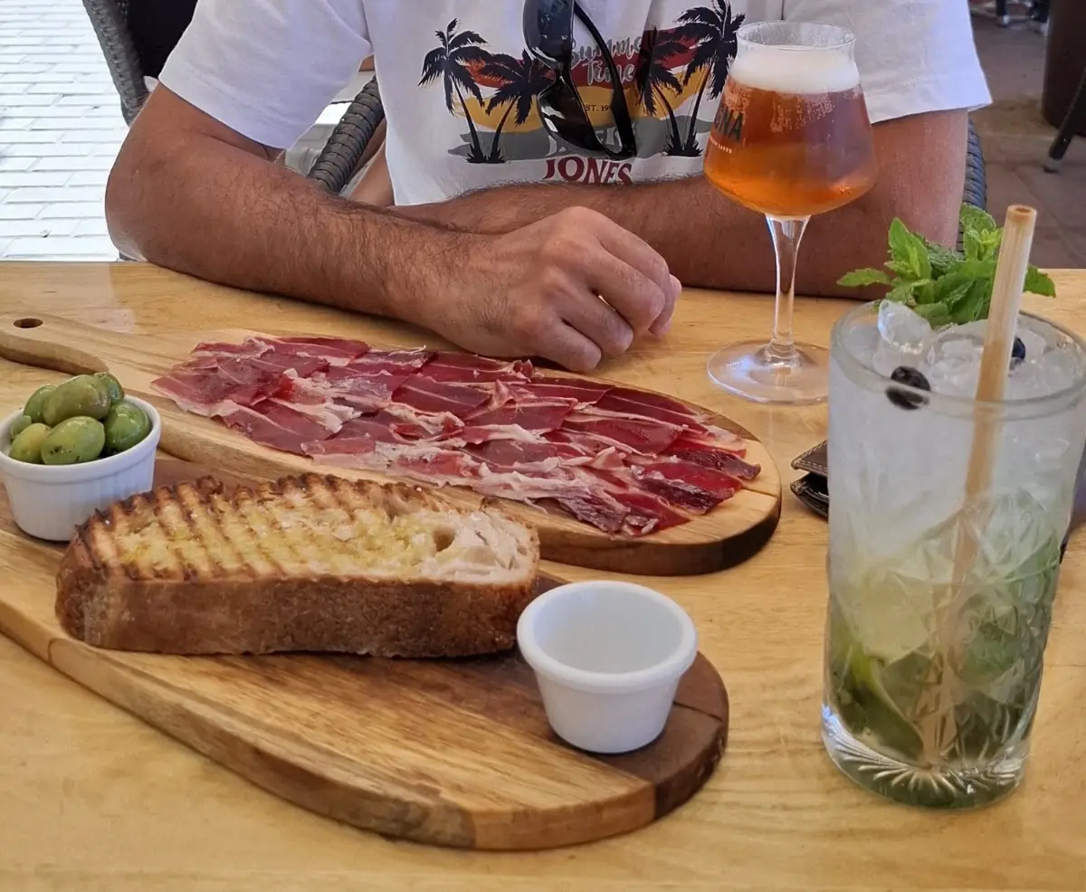 A charcuterie board with a cocktail at George's