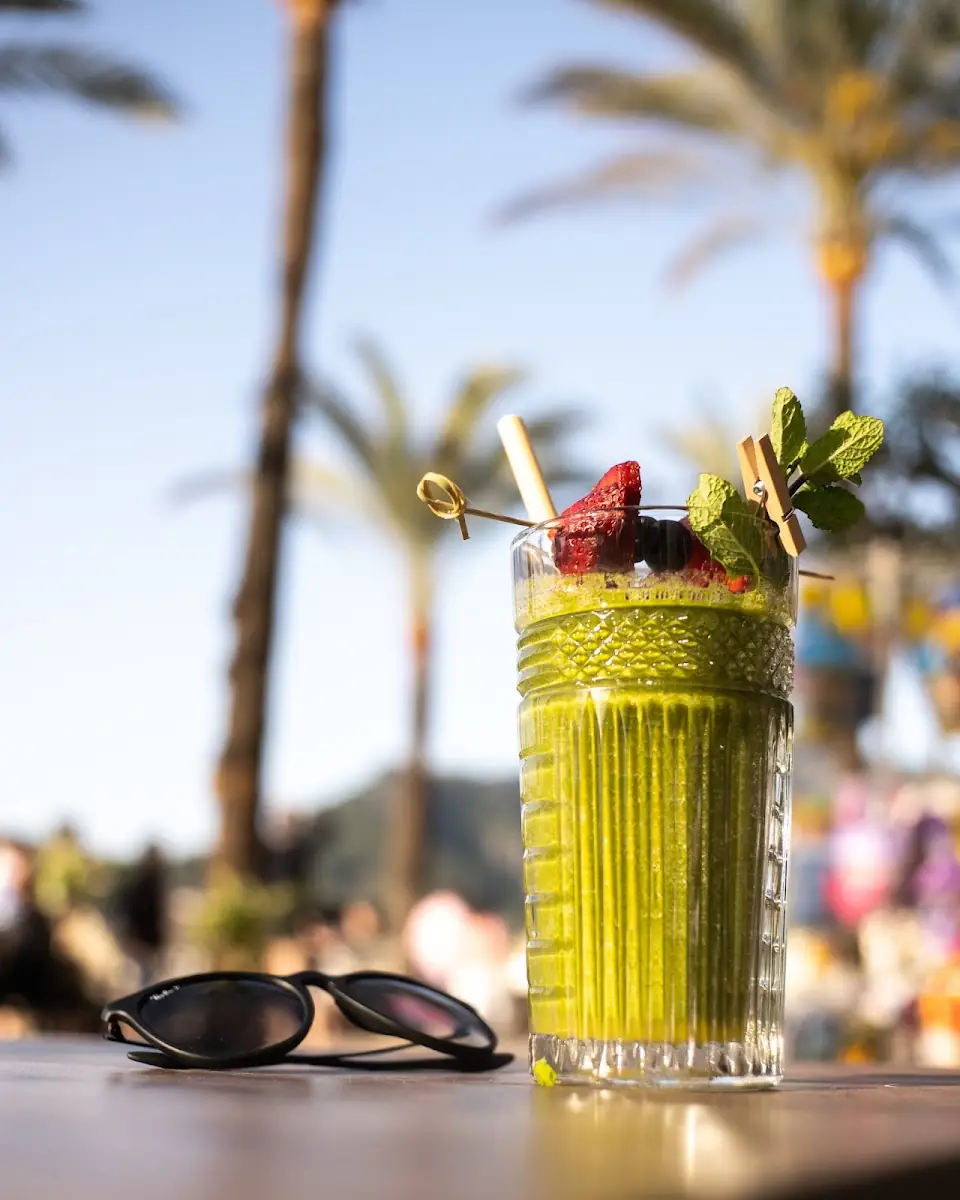 A cocktail at George's, with Port de Sóller behind