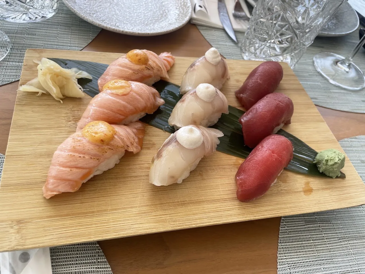 A wooden board of assorted nigiri sushi
