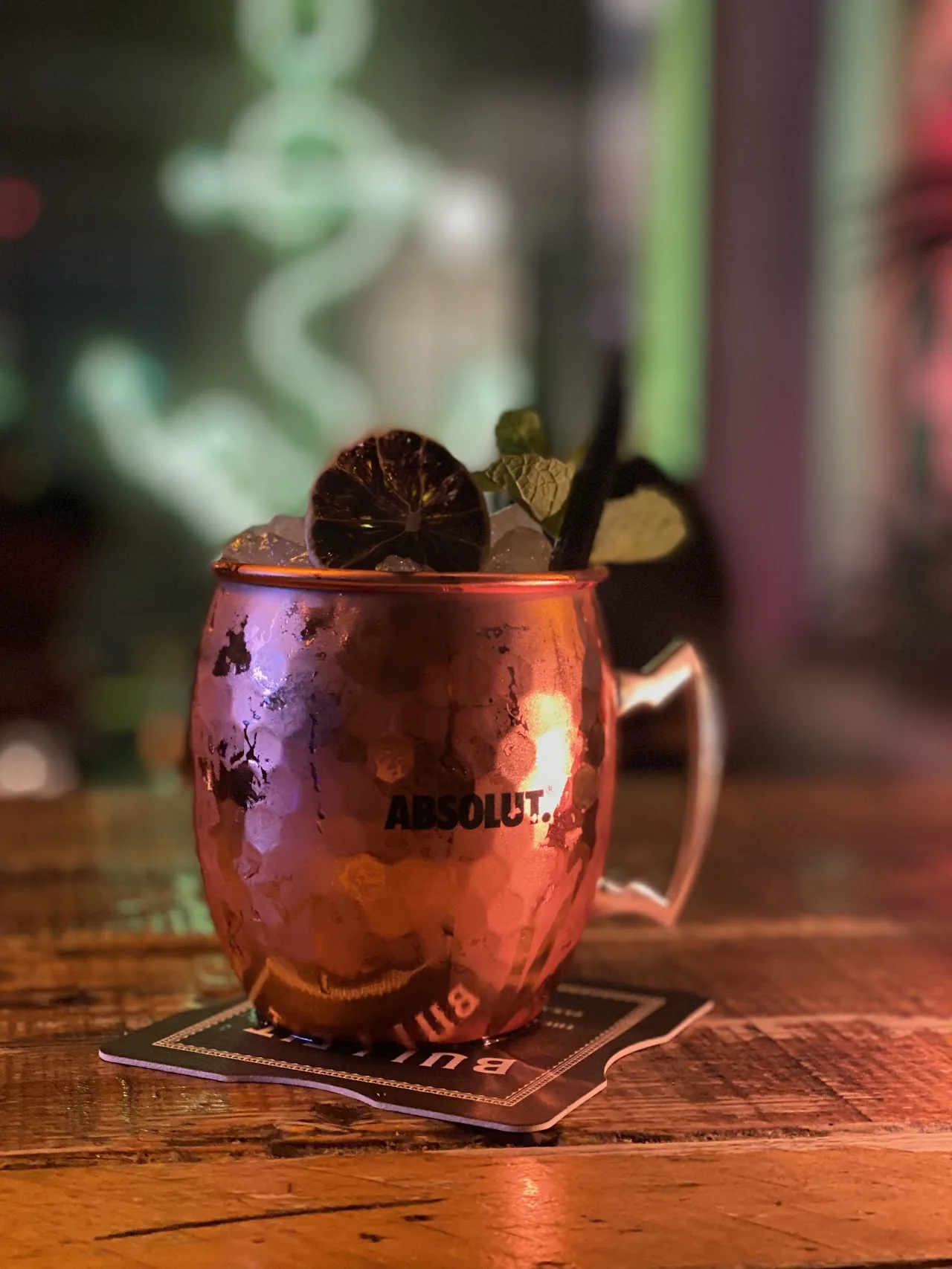 A copper mug cocktail garnished with fruit