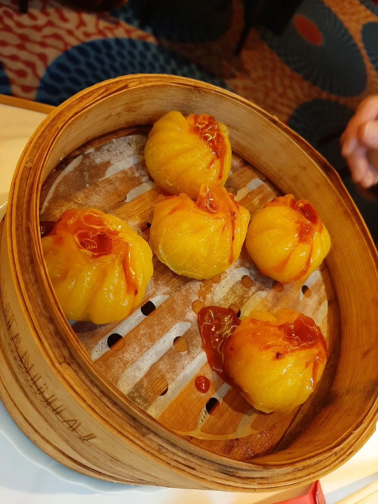 Golden dumplings in a bamboo steamer