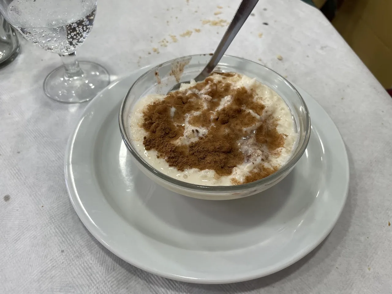 A bowl of rice pudding dusted with cinnamon
