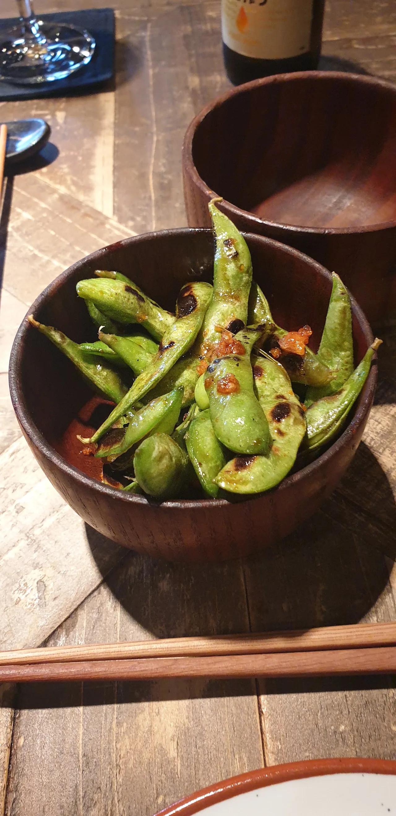 A bowl of edamame pods with chili flakes