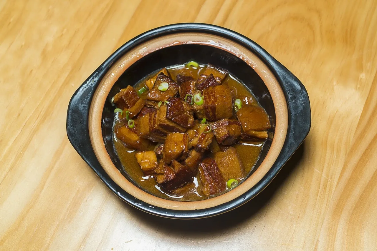 A clay pot of braised tofu in dark sauce