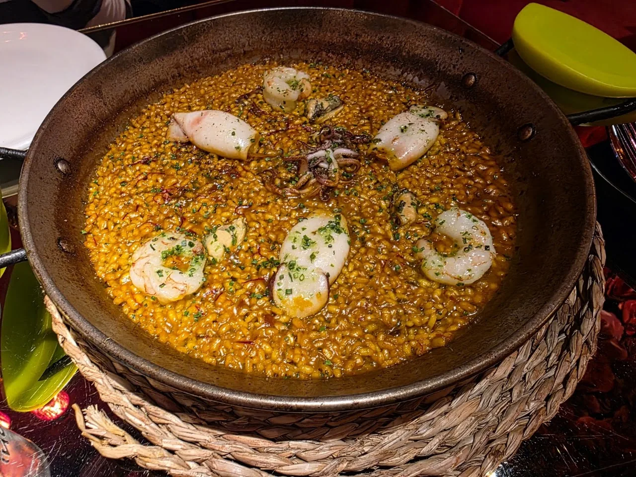 A paella topped with whole prawns and squid