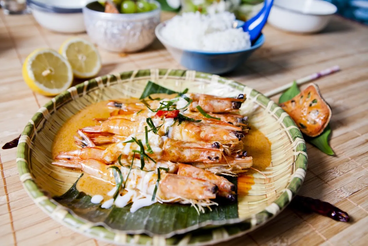 Grilled shrimp skewers on a banana leaf lined plate