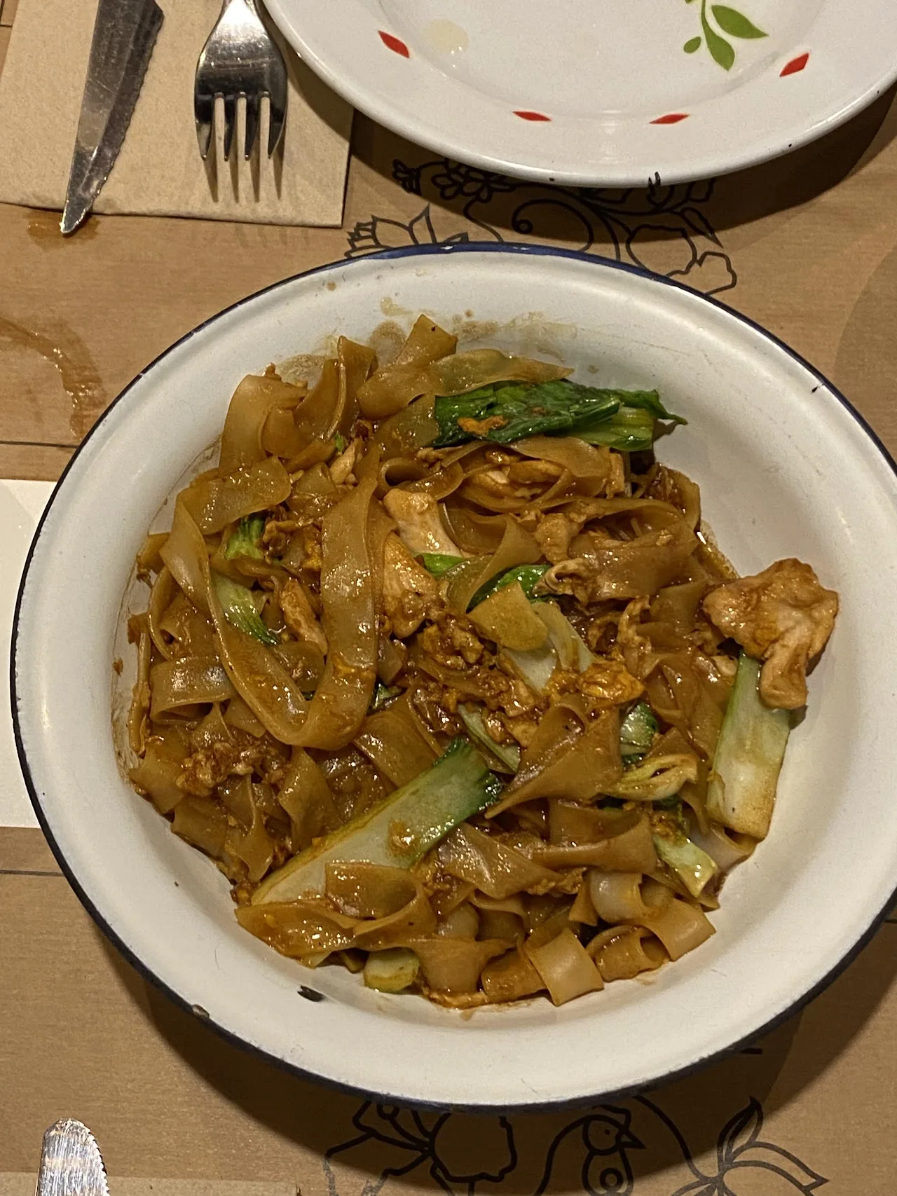 A plate of stir-fried noodles with vegetables