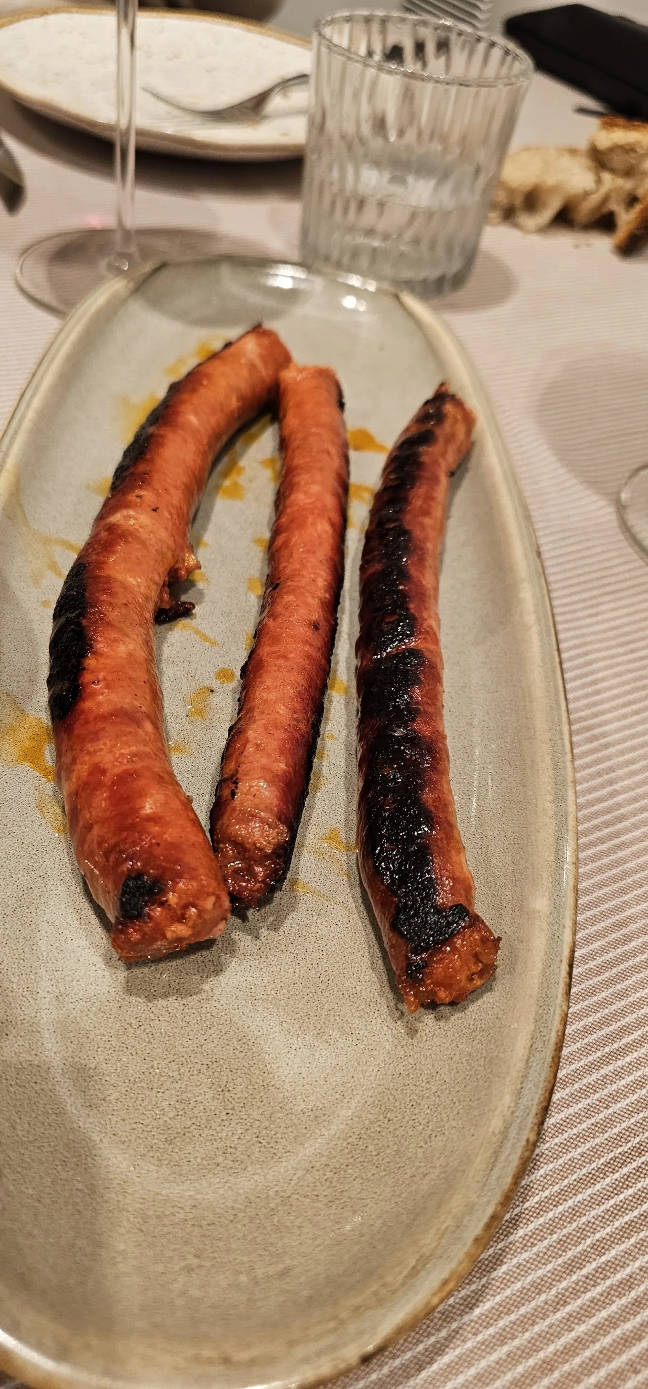 Two grilled chorizo sausages on a plate