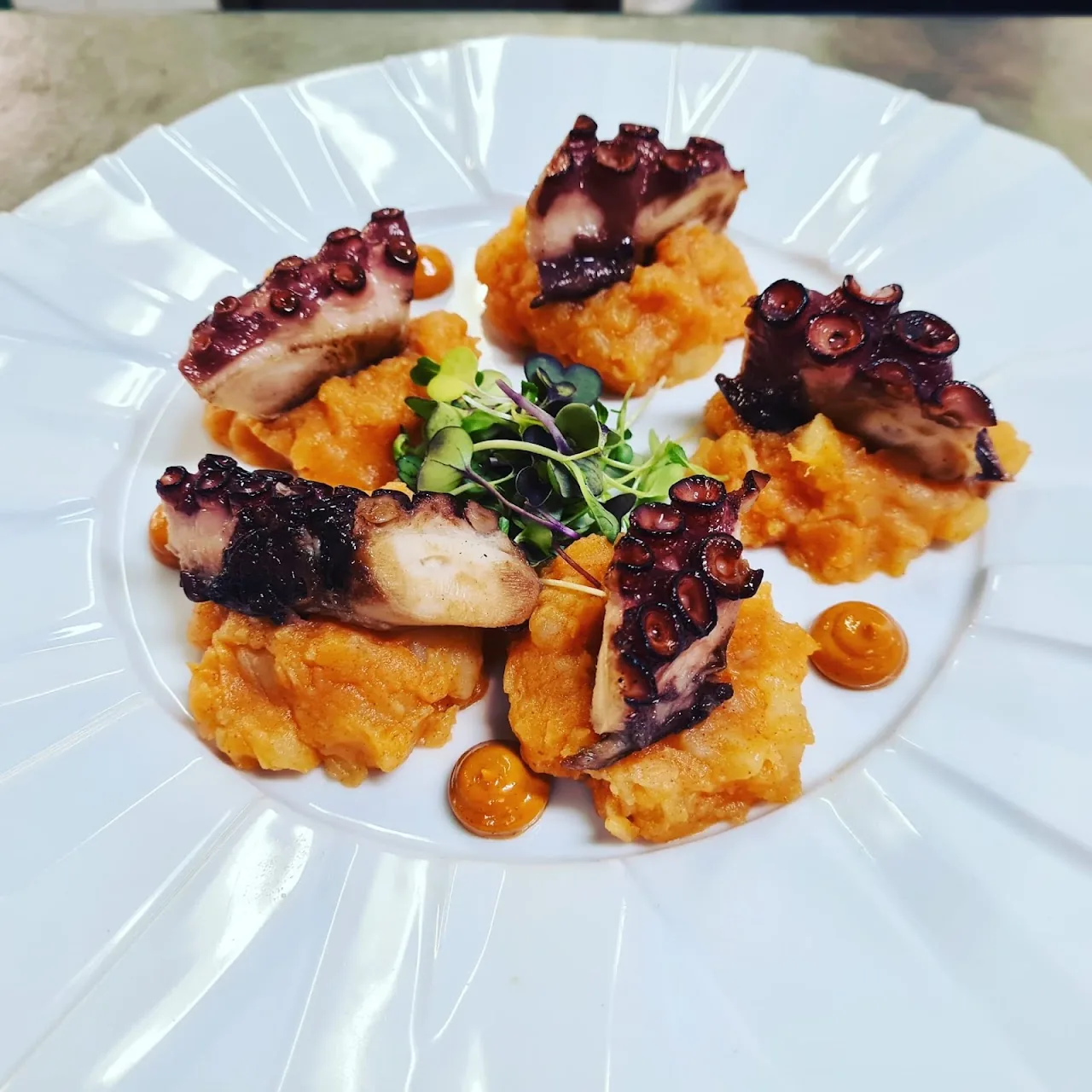 Grilled octopus with beet purée and citrus segments