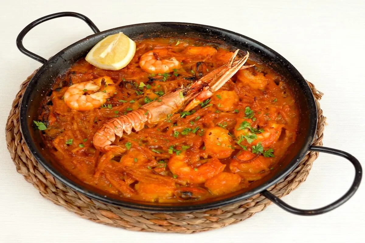 A pan of seafood paella with prawns and langoustine