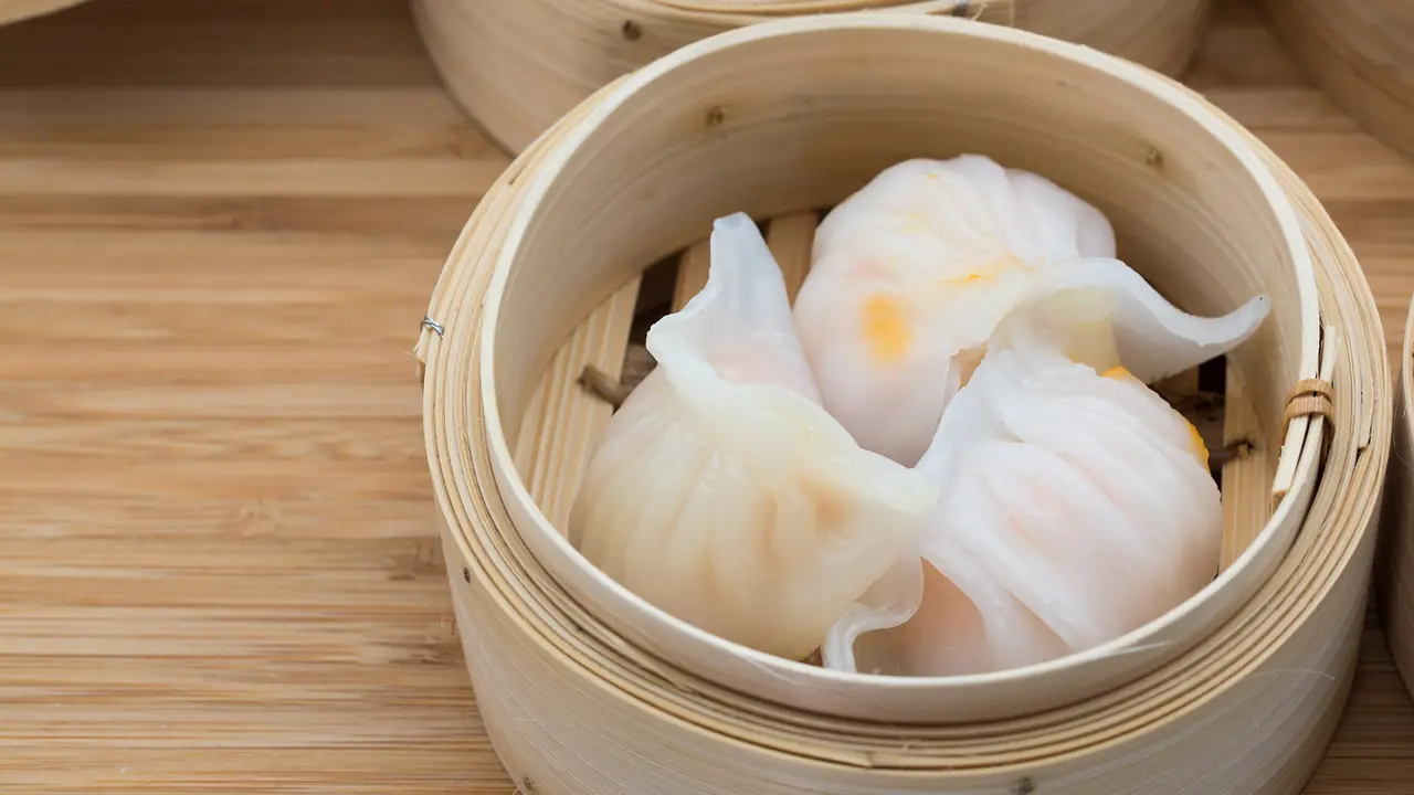 Steamed har gow dumplings in a bamboo steamer basket at Kao Dim Sum