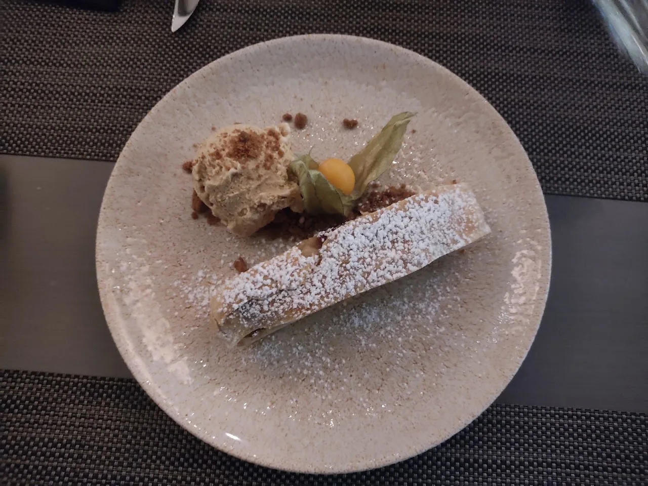 A slice of layered dessert cake dusted with powdered sugar
