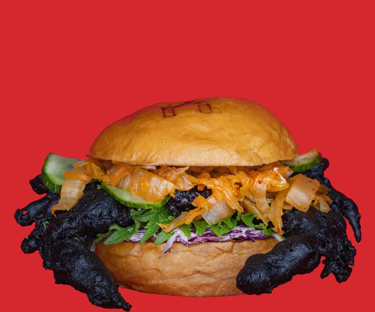 Fried soft-shell crab burger with kimchi, cucumber, shredded cabbage and mixed greens on a toasted bun, Kemako Japanese Burgers