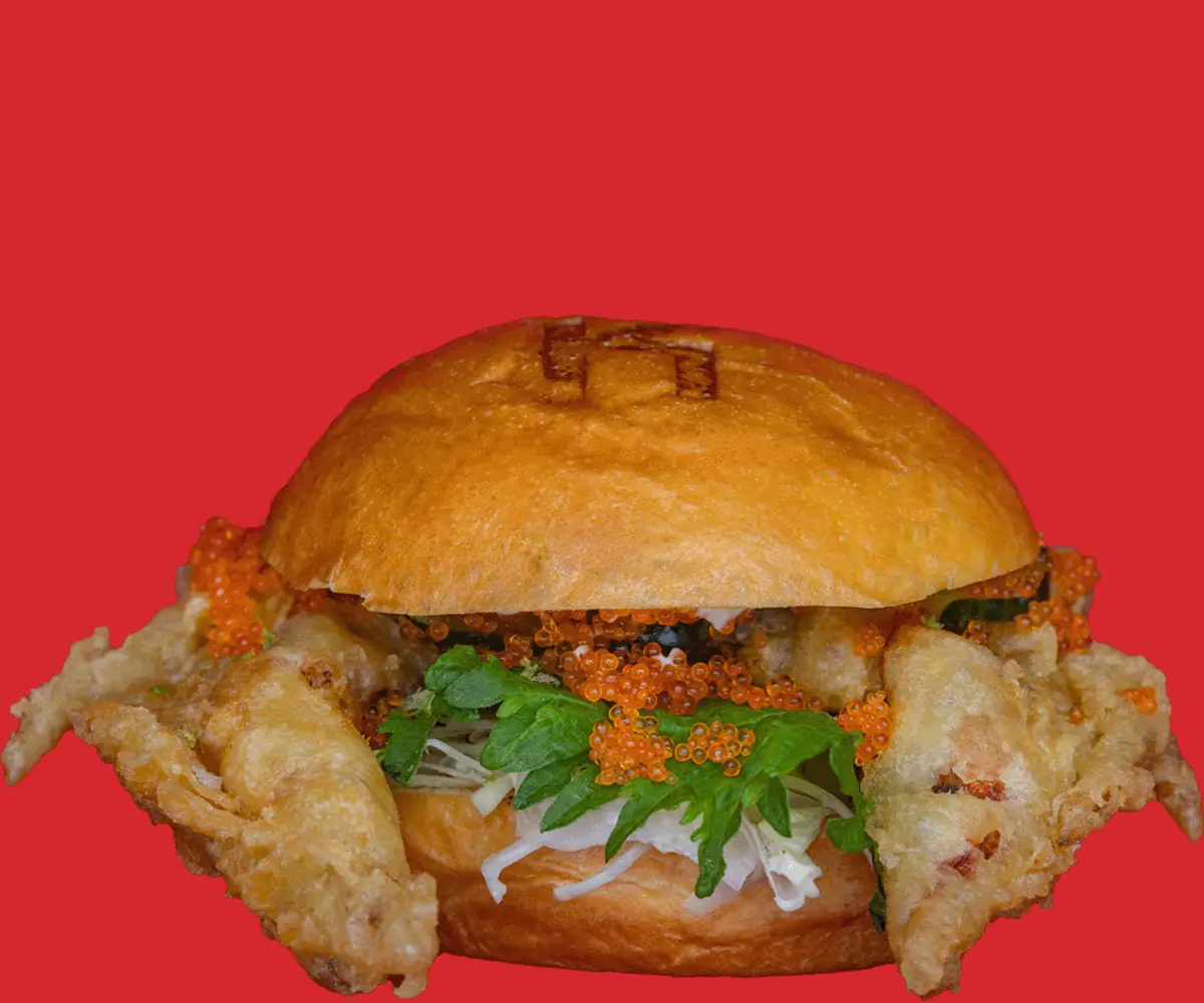 Tempura soft-shell crab burger topped with fish roe and greens on a toasted bun, Kemako Japanese Burgers
