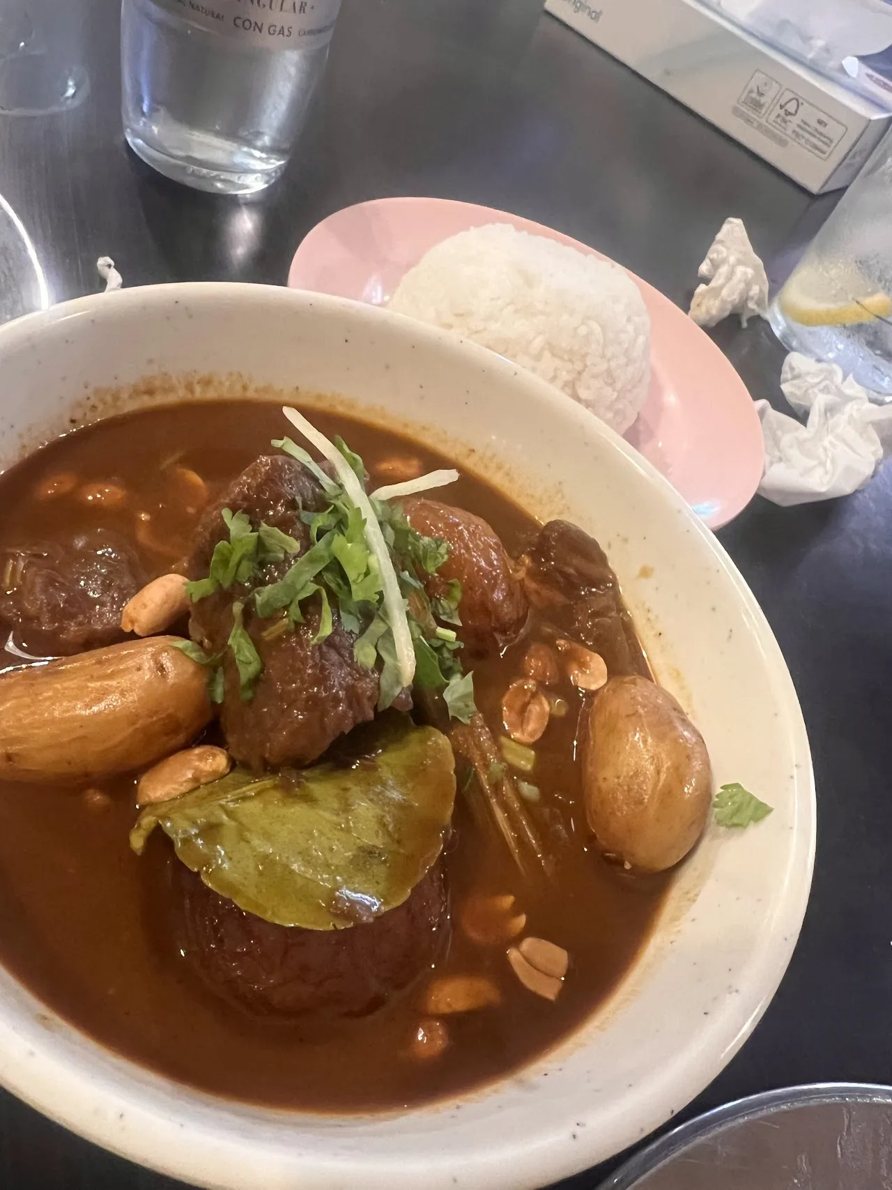 A stew with meatballs, boiled egg, and peanuts in dark sauce