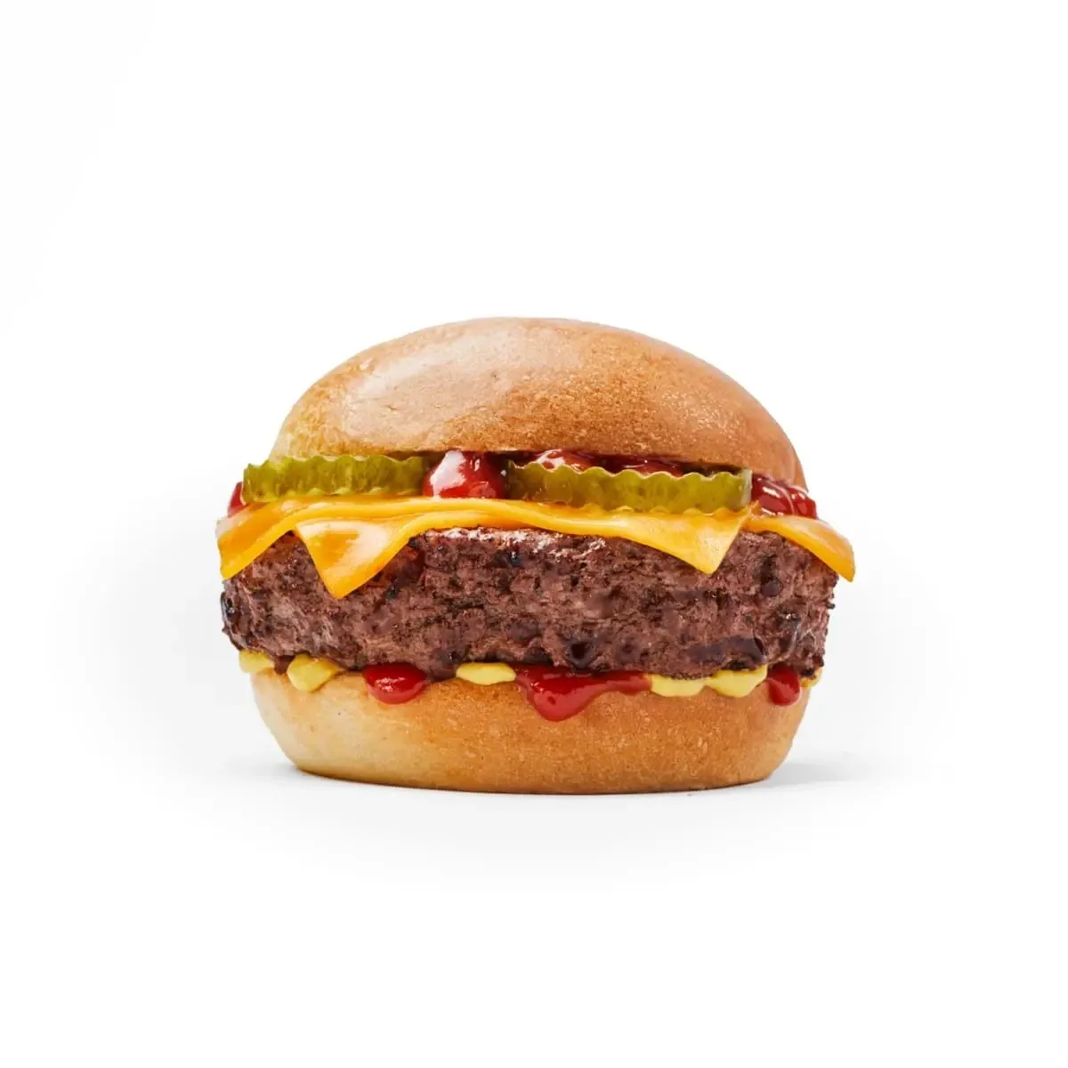 A cheeseburger with pickles and a glossy bun on a white background