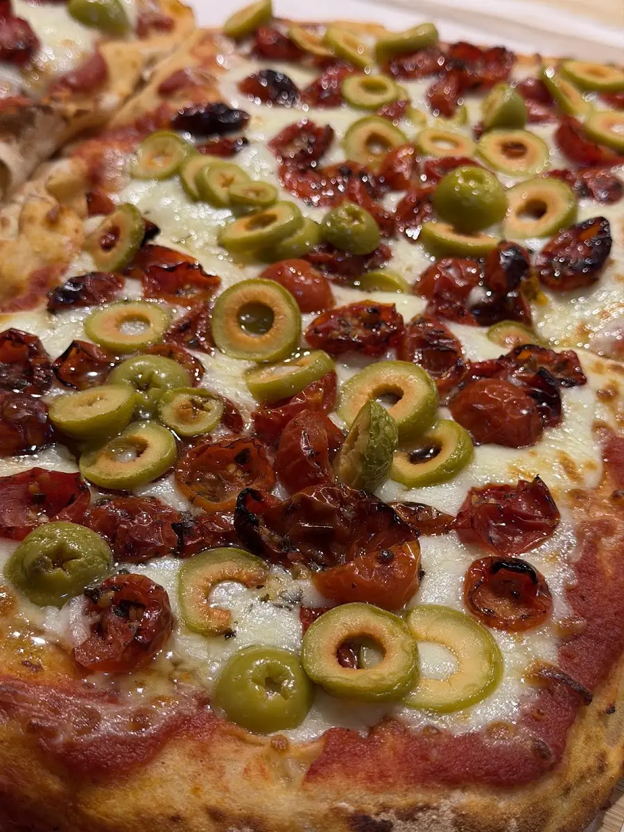 A coca flatbread with olives at L'Epicerie