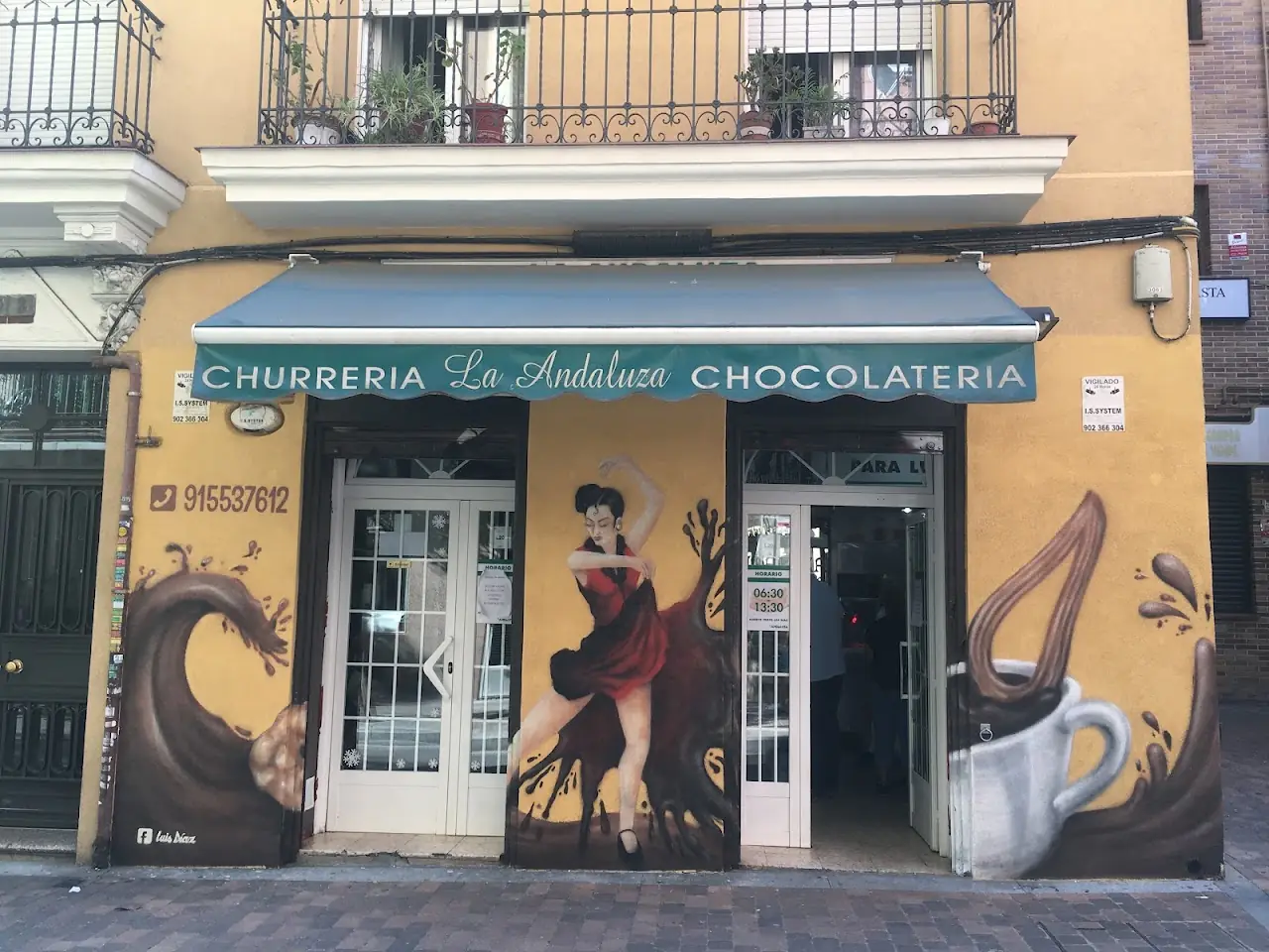 The Churrería La Andaluza frontage on Calle de Hernani, painted with a flamenco dancer, churros and a cup of chocolate